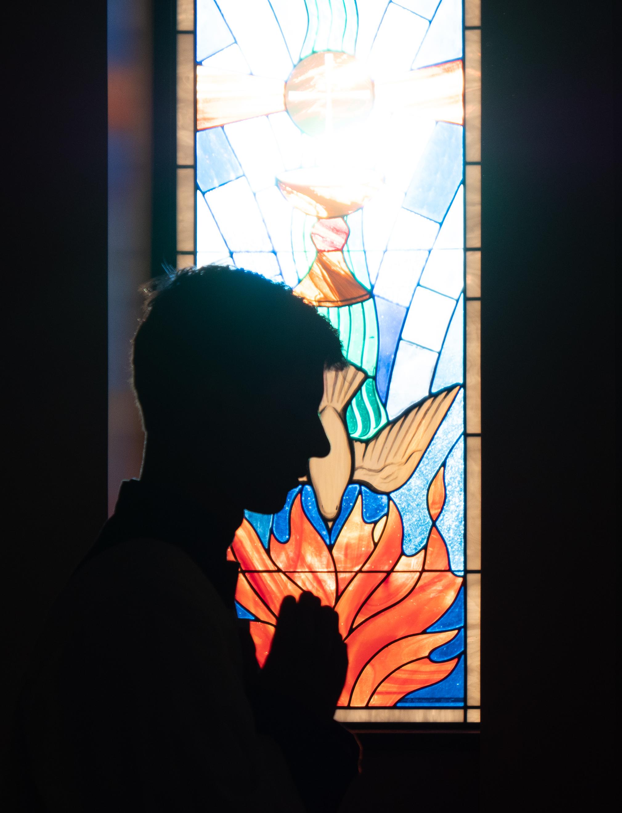 An altar boy silhouetted at the window
